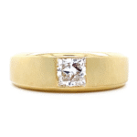 A modern men's wedding band in brushed yellow gold, featuring a tension-set radiant cut diamond, from the custom design collection at Catawba Island Jewelers in Port Clinton, Ohio.