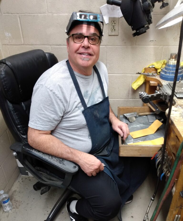 Carlo, the professional bench jeweler with over 40 years of experience, at his workshop in Catawba Island Jewelers, the trusted choice for on-site jewelry repair and custom design in Port Clinton, Ohio.